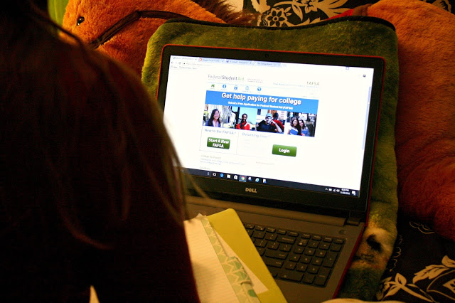 Understanding the FAFSA and College Admissions taking notes