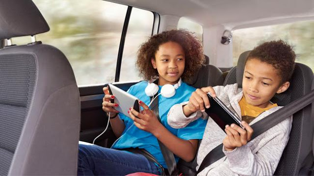 Teens on technology in a car